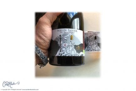 Wine bottle labeled "Mas de Figuier, Pic Saint Loup" with knight illustration.