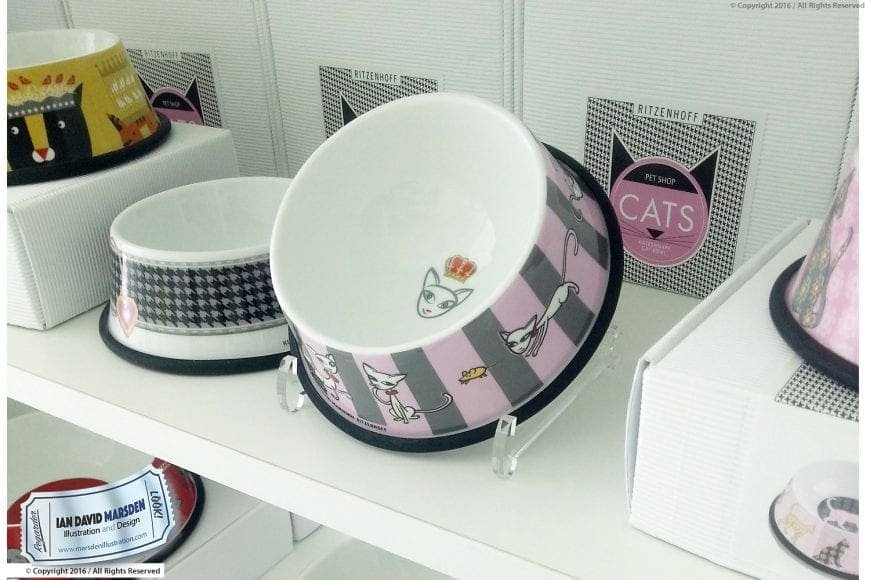 Decorative Ritzenhoff cat-themed pet bowls on a shelf with packaging in the background.