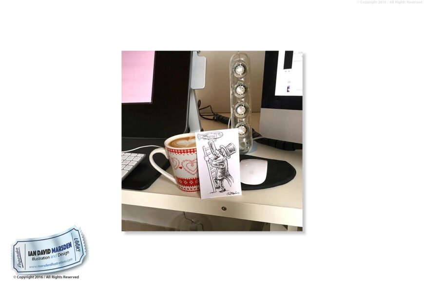 Computer desk with screen, keyboard, mug, illustration, and transparent speaker.