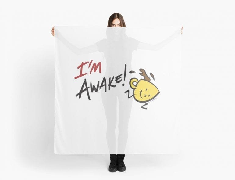 Person holding a cloth with "I'm Awake!" and a yellow steaming cup drawing.