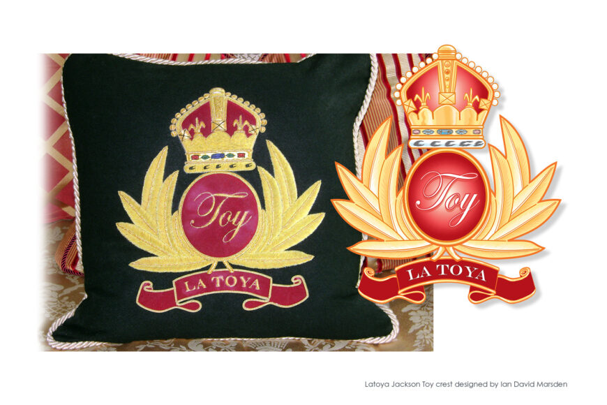 La Toya Jackson crest pillow with crown, initials, and red ribbon by Ian David Marsden
