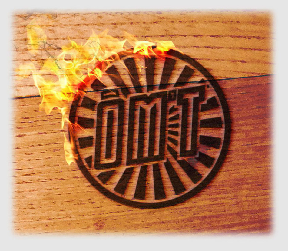 OMT logo branded on wood with flame effect for O Mas Troquet nightlife
