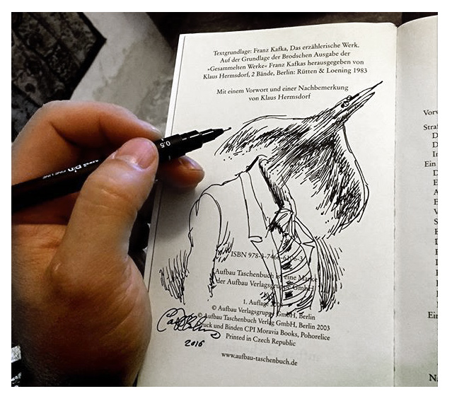 Sketch in a book margin showing a man mid-transformation, head flying upward as wings unfold.