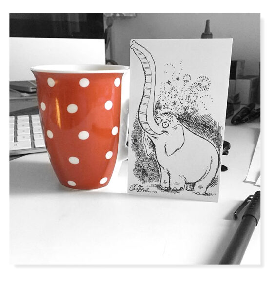 Playful scene of an elephant drawing propped against a polka-dot mug, as if caught mid-sip of the artist’s coffee.
