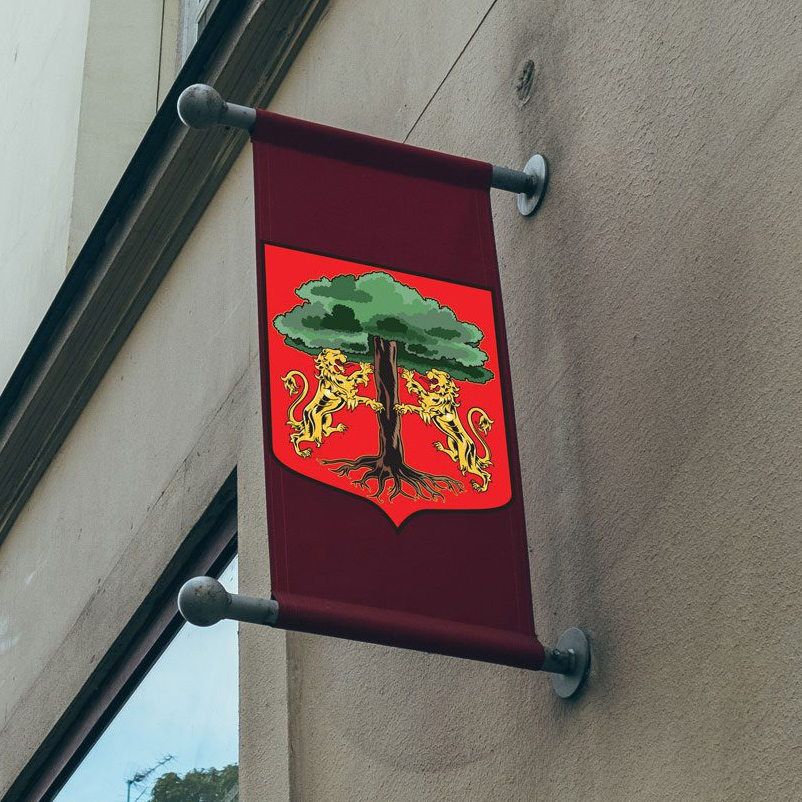 Red banner with shield emblem of two golden lions holding a tree, mounted on a wall.