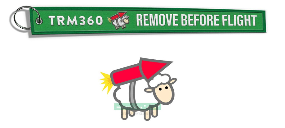 Green keychain with "TRM360 REMOVE BEFORE FLIGHT" and cartoon sheep with a rocket.