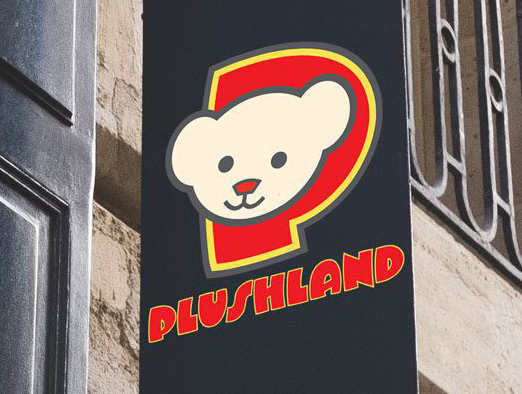 Sign with cartoon bear in a "P" above "Plushland" on building exterior.