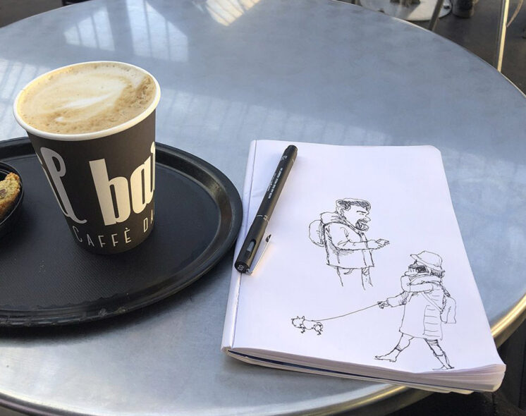 Ballpoint sketch of Paris train station café scene with coffee, pastry, and seated travelers.