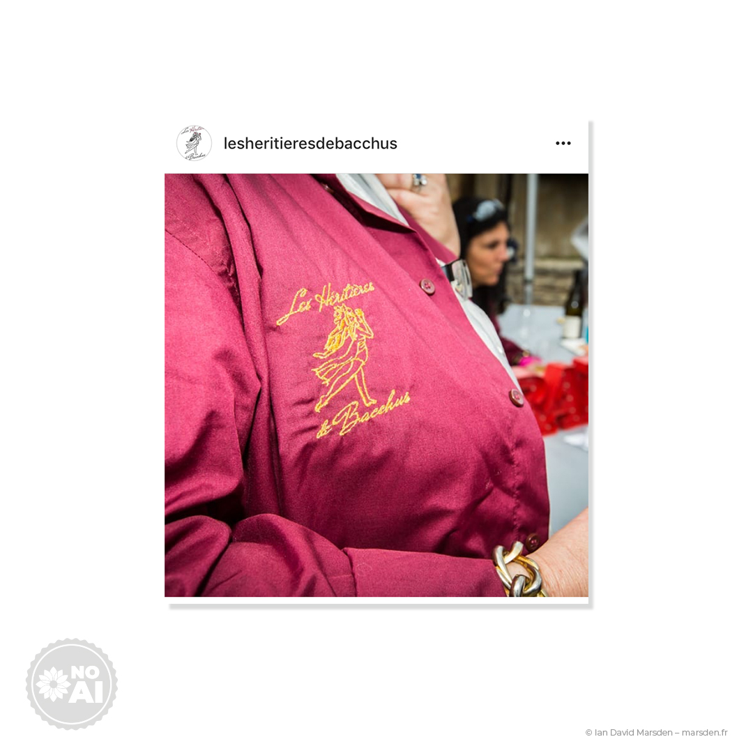 Embroidered wine vest with Les Héritiè​res de Bacchus logo, event apparel branding.
