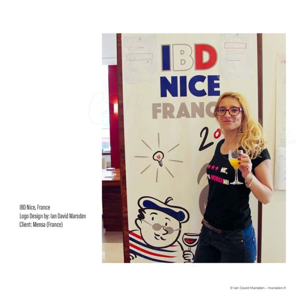 Photograph of Mensa IBD 2017 logo poster with smiling attendee in front of mascot illustration