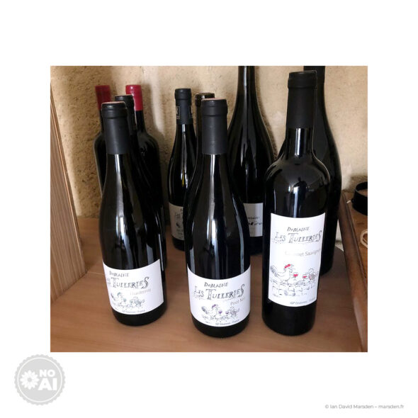 Three produced Domaine Les Tuileries bottles for Chardonnay, Pinot Noir and Cabernet Sauvignon with illustrated wine labels.