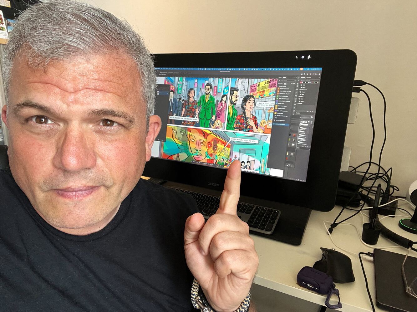 Ian David Marsden in his studio with a page from the Samara bande dessinée displayed on a Wacom drawing screen.