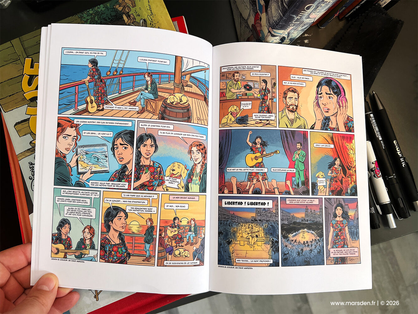 Printed double-page bande dessinée spread from Samara showing an ocean scene and a live stage performance, illustrated and colored by Ian David Marsden.